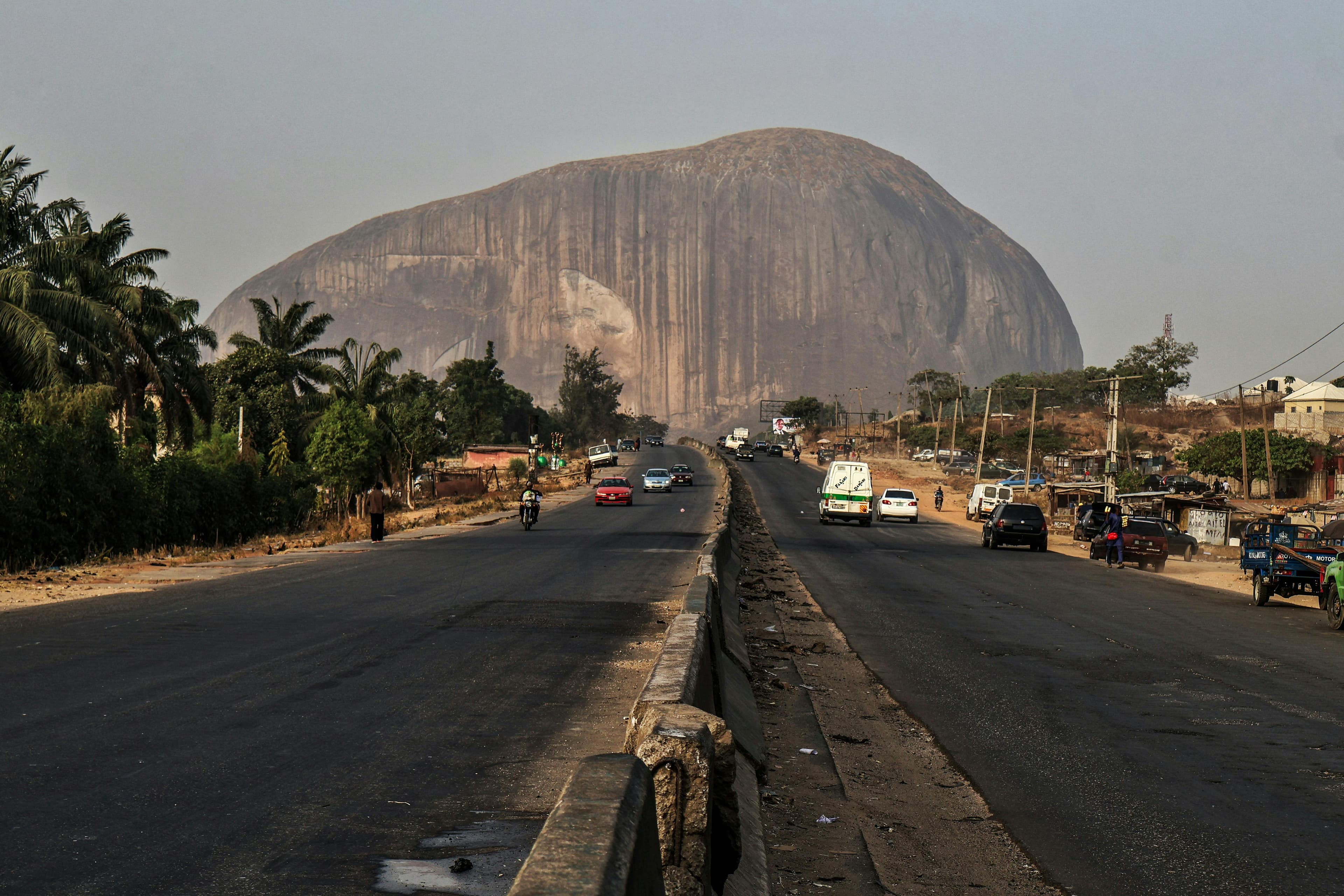 A street in Abuja with Aso Rock rising in the background